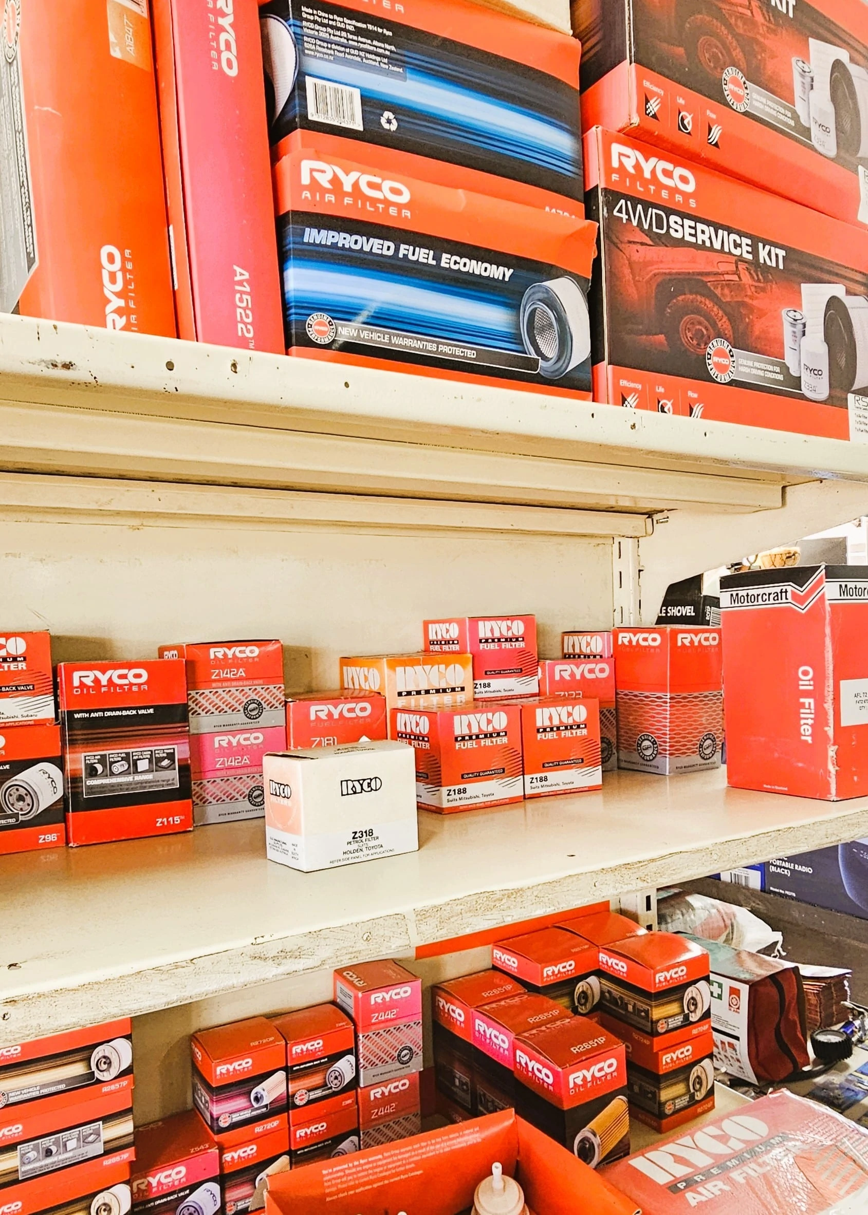 A store interior filled with various car parts displayed on shelves and racks.